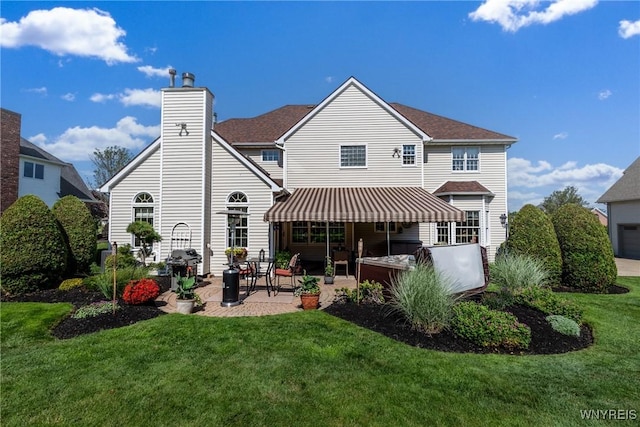 5477 Pebble Beach Dr, Hamburg, NY 14075 - back of house featuring a lawn, a patio, and a chimney