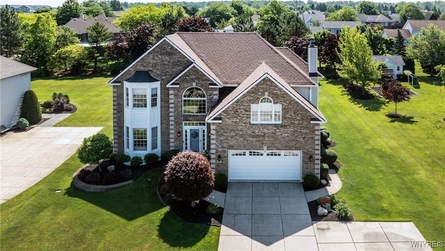 5477 Pebble Beach Dr, Hamburg, NY 14075 - traditional-style house featuring concrete driveway, an attached garage, a chimney, a front lawn, and brick siding