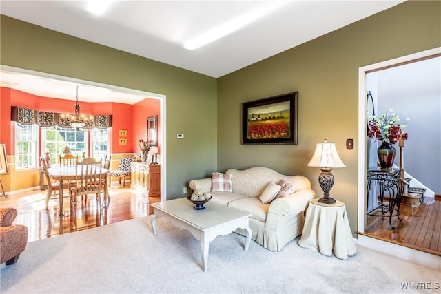 5477 Pebble Beach Dr, Hamburg, NY 14075 - carpeted living room with a chandelier and baseboards