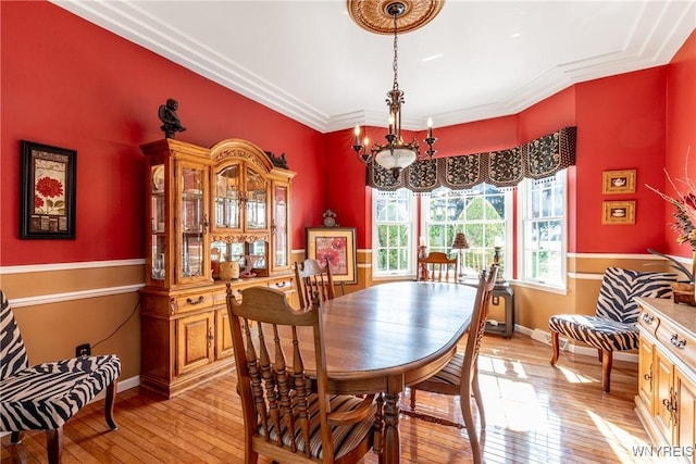 5477 Pebble Beach Dr, Hamburg, NY 14075 - dining area featuring light wood-type flooring and crown molding