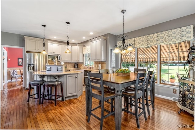 5477 Pebble Beach Dr, Hamburg, NY 14075 - dining room with hardwood / wood-style flooring, plenty of natural light, a chandelier, and recessed lighting