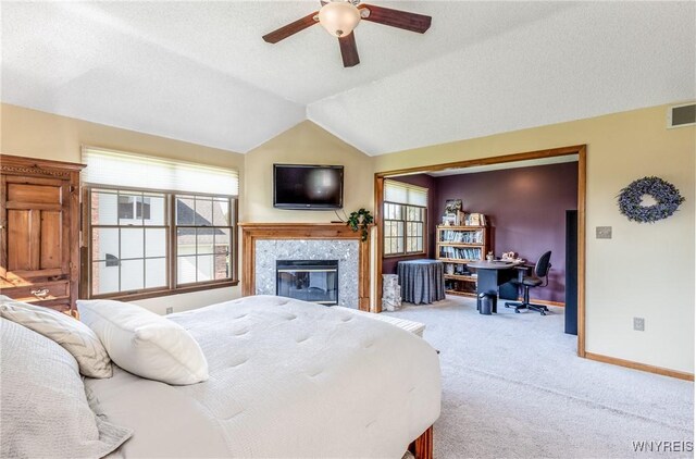 5477 Pebble Beach Dr, Hamburg, NY 14075 - bedroom featuring an office area, carpet floors, a fireplace, vaulted ceiling, and ceiling fan