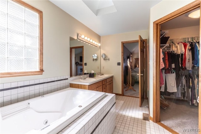 5477 Pebble Beach Dr, Hamburg, NY 14075 - bathroom featuring double vanity, a tub with jets, a spacious closet, and tile patterned floors