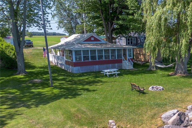10337 Chaffee Ln, Yates, NY 14098 - rear view of property featuring a sunroom and a lawn