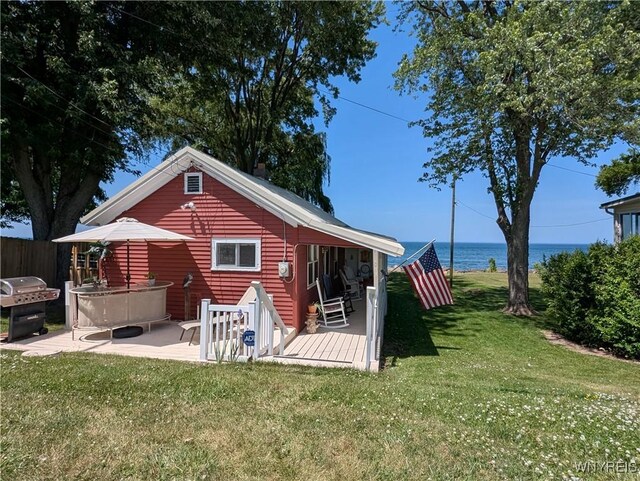 10337 Chaffee Ln, Yates, NY 14098 - rear view of house featuring a lawn, a patio area, and a deck with water view