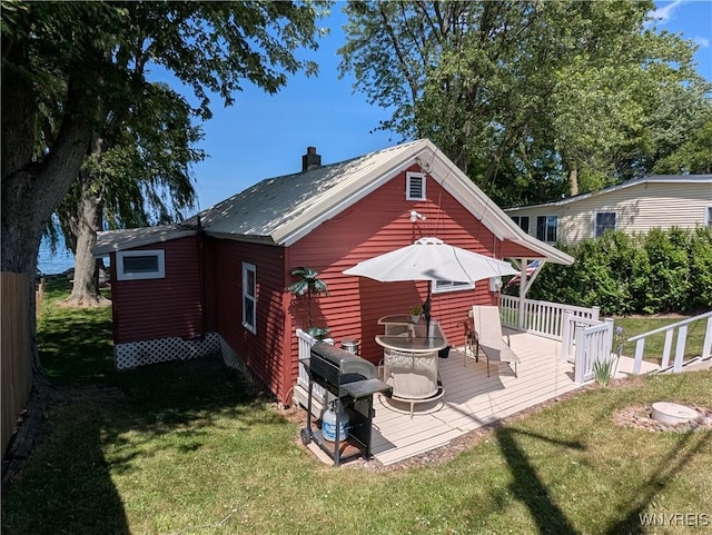 10337 Chaffee Ln, Yates, NY 14098 - back of property featuring a deck, a yard, a metal roof, and a chimney