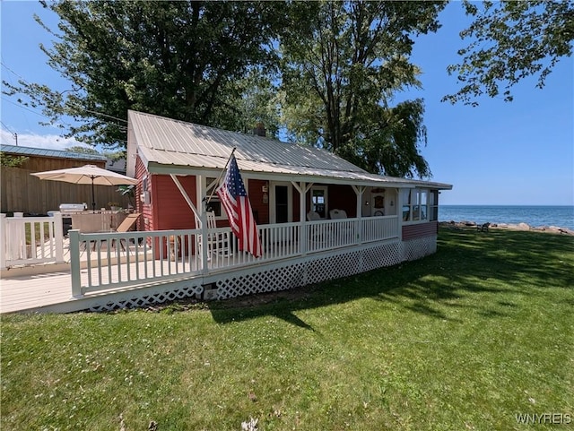 10337 Chaffee Ln, Yates, NY 14098 - view of front of property with a water view, a front lawn, a metal roof, and covered porch