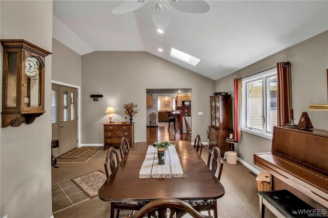 8515 Rte 243, Rushford, NY 14777 - carpeted dining space featuring ceiling fan, vaulted ceiling, and a skylight
