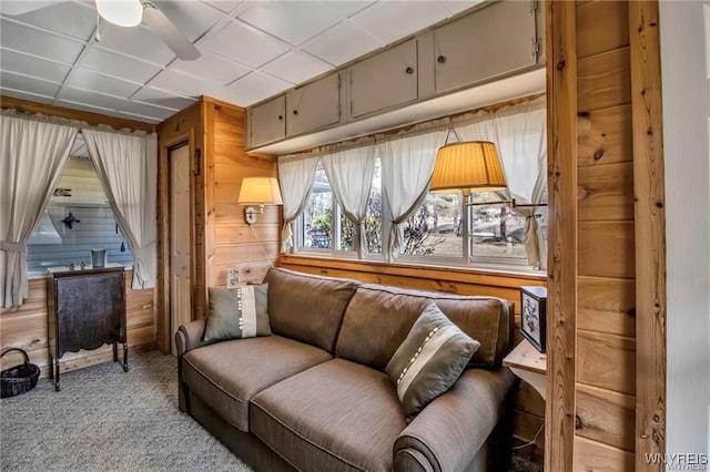 8515 Rte 243, Rushford, NY 14777 - carpeted living room with ceiling fan and wooden walls