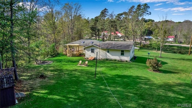 8515 Rte 243, Rushford, NY 14777 - rear view of property featuring a yard, a deck, and a view of trees
