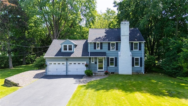 80 Rock Beach Rd, Irondequoit, NY 14617 - view of front of house with asphalt driveway, an attached garage, a front yard, a chimney, and a shingled roof