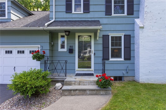 80 Rock Beach Rd, Irondequoit, NY 14617 - view of exterior entry featuring a garage and a shingled roof