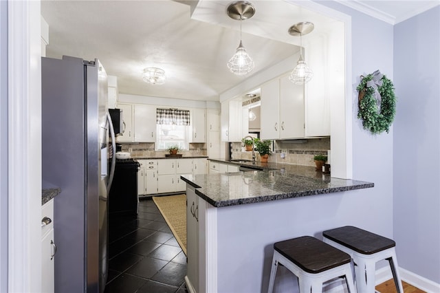 80 Rock Beach Rd, Irondequoit, NY 14617 - kitchen with stainless steel fridge with ice dispenser, a peninsula, decorative backsplash, white cabinets, and a breakfast bar area