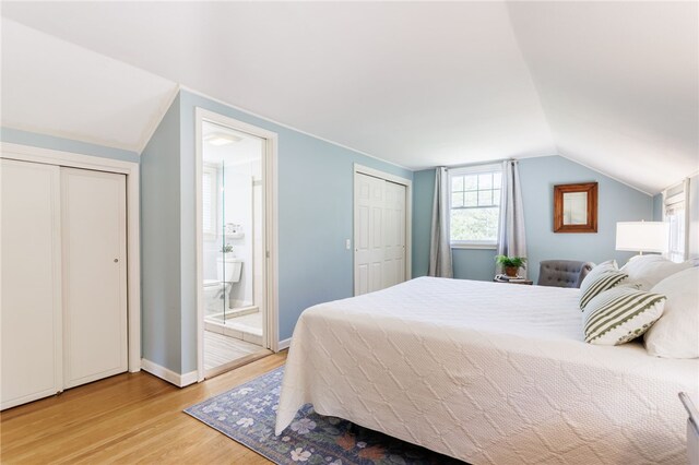 80 Rock Beach Rd, Irondequoit, NY 14617 - bedroom featuring light wood-style flooring, vaulted ceiling, ensuite bathroom, and two closets