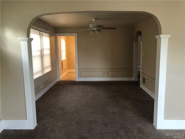 29 Avery Ave, Buffalo, NY 14216 - unfurnished room with dark colored carpet, a ceiling fan, and arched walkways