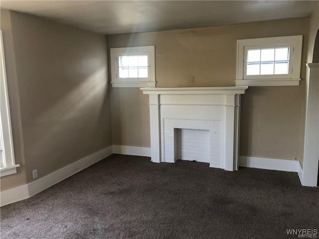29 Avery Ave, Buffalo, NY 14216 - unfurnished living room featuring a fireplace and dark colored carpet