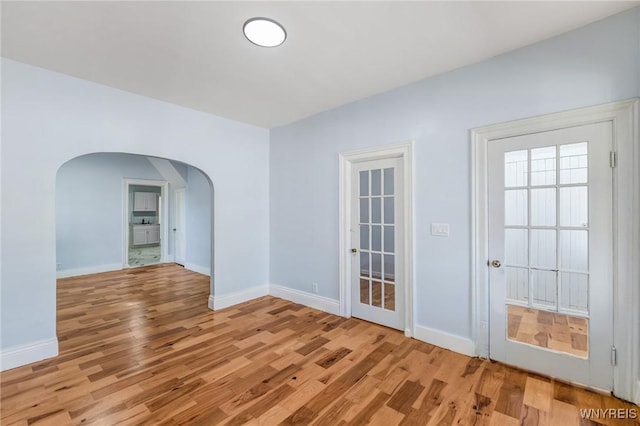 152 Mulberry St, Buffalo, NY 14204 - spare room with arched walkways and light wood-style floors