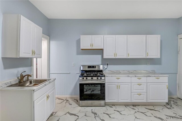 152 Mulberry St, Buffalo, NY 14204 - kitchen with stainless steel gas range, light marble finish flooring, and white cabinets