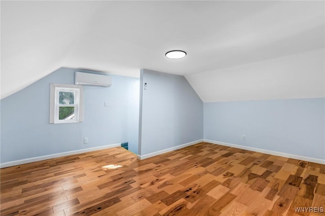 152 Mulberry St, Buffalo, NY 14204 - additional living space with a wall mounted AC, lofted ceiling, and light wood-type flooring