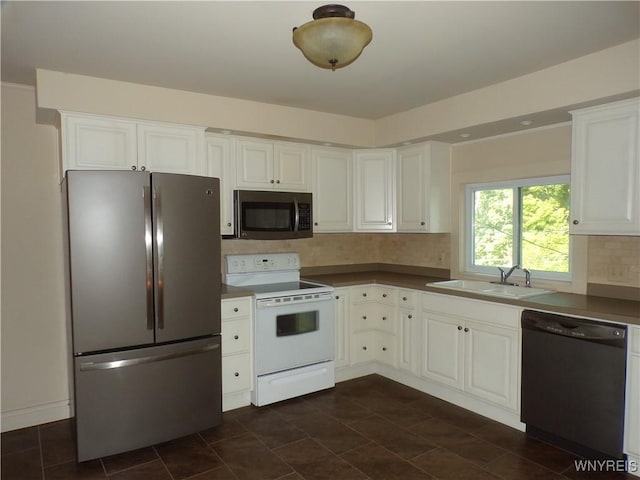 315 Laurens St, Olean-City, NY 14760 - kitchen with appliances with stainless steel finishes, tasteful backsplash, white cabinets, and dark countertops