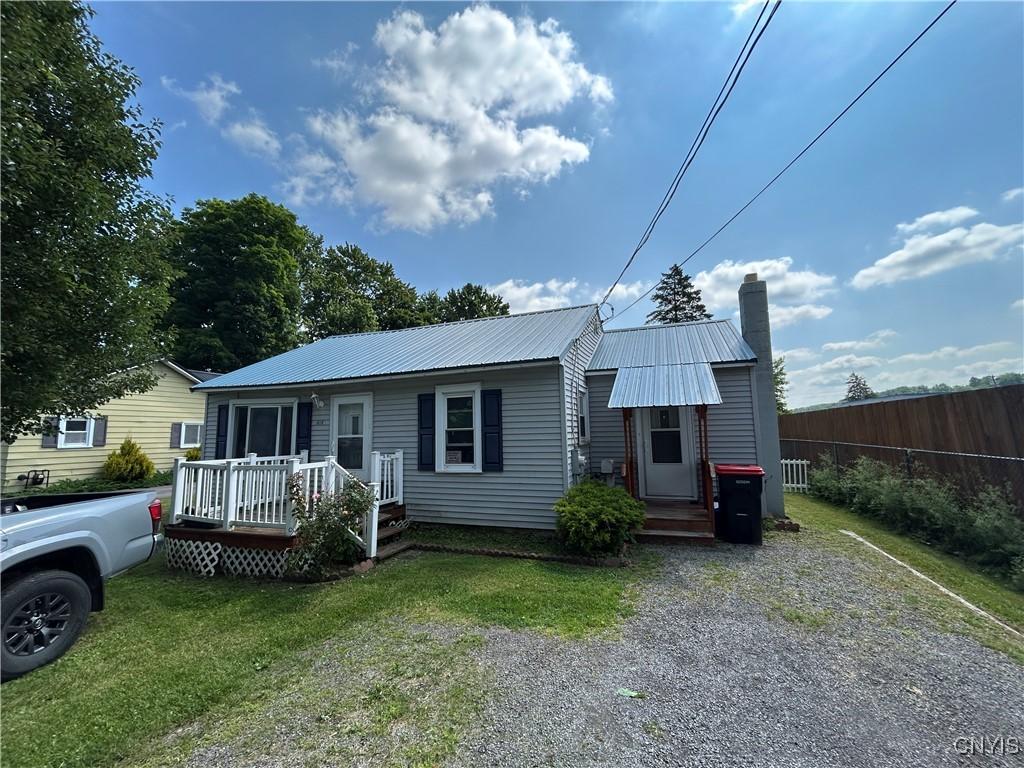 612 Manor Dr, Sullivan, NY 13037 - view of front facade featuring a chimney, a metal roof, and a deck