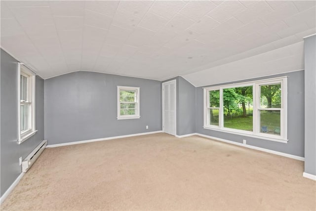 917 Whalen Rd, Penfield, NY 14526 - spare room featuring a baseboard heating unit, lofted ceiling, and carpet floors