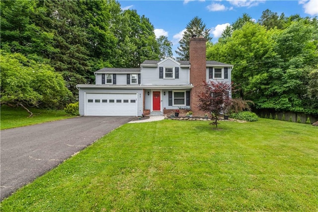 917 Whalen Rd, Penfield, NY 14526 - traditional-style home with asphalt driveway, a chimney, a front yard, and brick siding