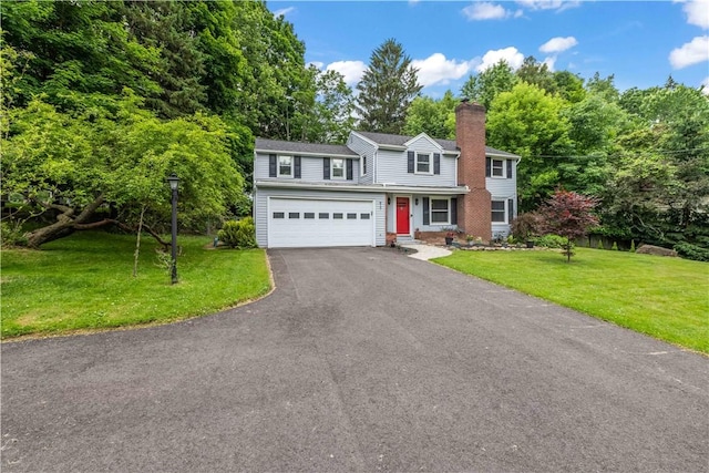 917 Whalen Rd, Penfield, NY 14526 - view of front of property featuring asphalt driveway, a chimney, a front lawn, and an attached garage
