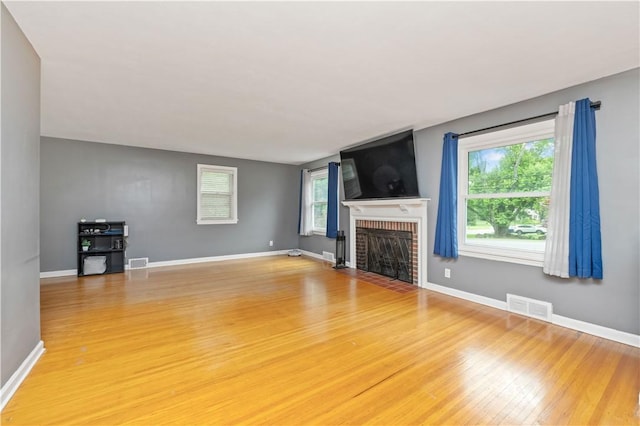 917 Whalen Rd, Penfield, NY 14526 - unfurnished living room with light wood finished floors and a fireplace