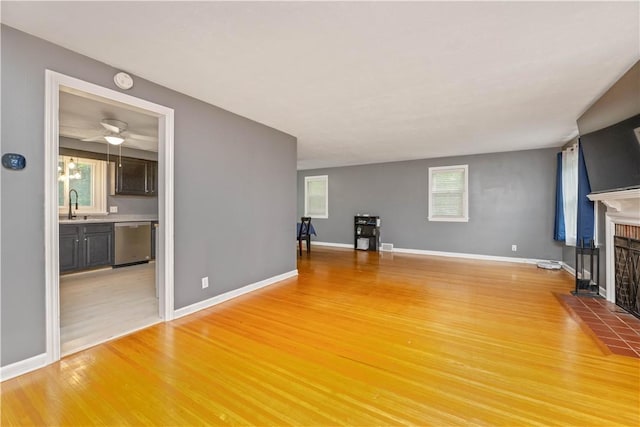 917 Whalen Rd, Penfield, NY 14526 - unfurnished living room with light wood-type flooring, a fireplace, and ceiling fan