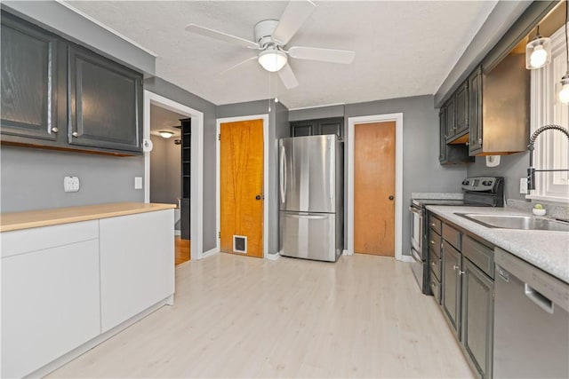 917 Whalen Rd, Penfield, NY 14526 - kitchen featuring appliances with stainless steel finishes, light wood-style floors, ceiling fan, and light countertops