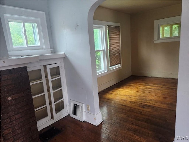 609 W Colvin St, Syracuse, NY 13205 - spare room featuring arched walkways and hardwood / wood-style floors