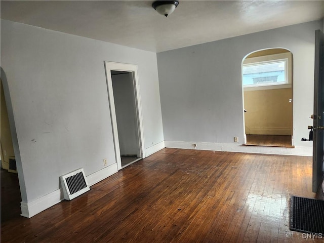 609 W Colvin St, Syracuse, NY 13205 - empty room featuring wood-type flooring and arched walkways
