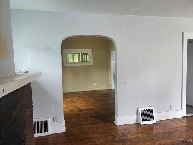 609 W Colvin St, Syracuse, NY 13205 - unfurnished living room with arched walkways and wood-type flooring