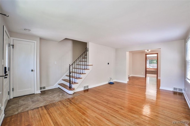 218 Hamilton Dr, Amherst, NY 14226 - unfurnished living room featuring light wood-type flooring and stairway