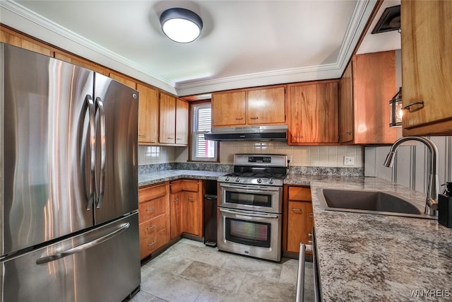 218 Hamilton Dr, Amherst, NY 14226 - kitchen with stainless steel appliances, under cabinet range hood, brown cabinets, ornamental molding, and backsplash