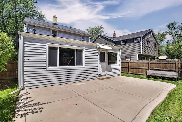 218 Hamilton Dr, Amherst, NY 14226 - back of property with a patio area and a chimney