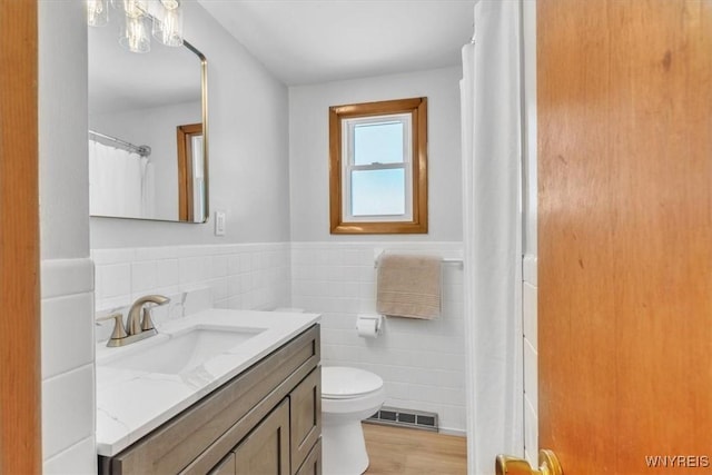 190 Gary Ln, Cheektowaga, NY 14227 - bathroom with tile walls, vanity, wood finished floors, and wainscoting