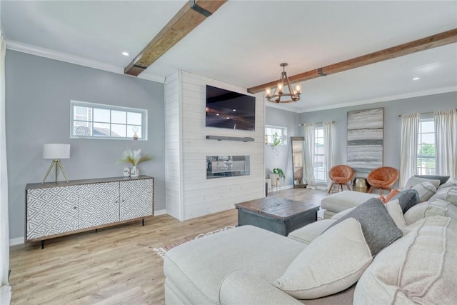 28 Blaydon Loop, Henrietta, NY 14586 - living room featuring beam ceiling, a chandelier, wood finished floors, a large fireplace, and plenty of natural light