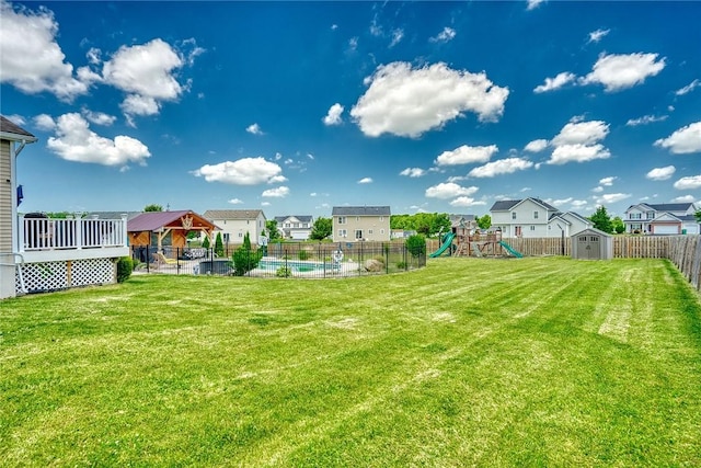 28 Blaydon Loop, Henrietta, NY 14586 - fenced backyard with a gazebo, a playground, a storage unit, and a residential view