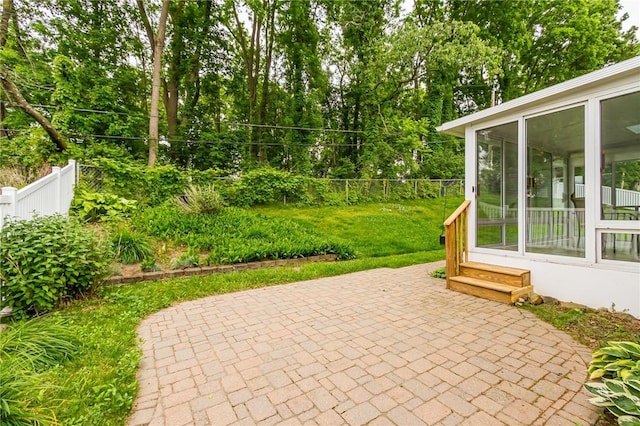 45 Barnfield Rd, Henrietta, NY 14534 - fenced backyard with a sunroom, a patio, and view of wooded area