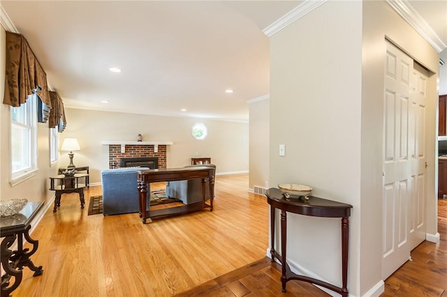 45 Barnfield Rd, Henrietta, NY 14534 - living room with ornamental molding, light wood finished floors, a fireplace, and recessed lighting