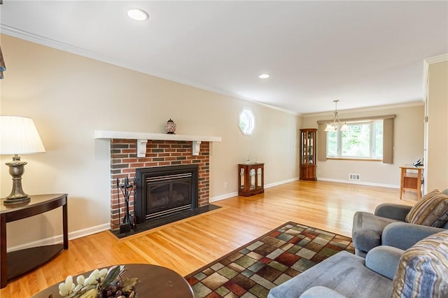 45 Barnfield Rd, Henrietta, NY 14534 - living area featuring crown molding, wood finished floors, a brick fireplace, and recessed lighting