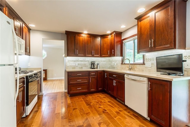 45 Barnfield Rd, Henrietta, NY 14534 - kitchen featuring white appliances, hardwood / wood-style flooring, light countertops, decorative backsplash, and recessed lighting