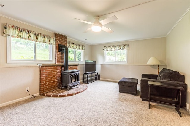45 Barnfield Rd, Henrietta, NY 14534 - sitting room featuring a wood stove, ornamental molding, ceiling fan, and carpet flooring