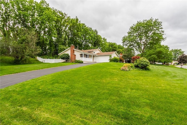 45 Barnfield Rd, Henrietta, NY 14534 - mid-century modern home featuring driveway, a chimney, and an attached garage