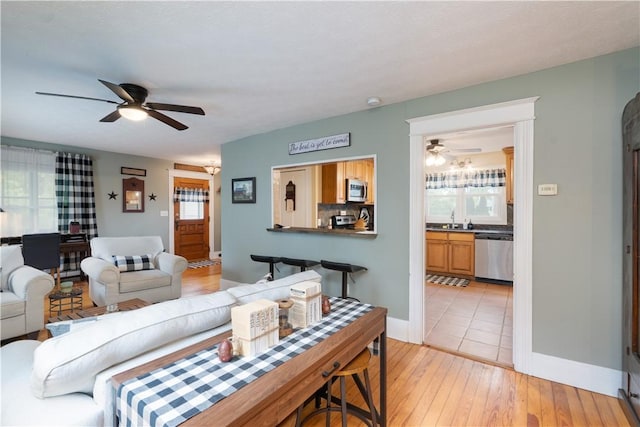 70 E Main St, Avon, NY 14414 - living room with a ceiling fan and light wood-style floors