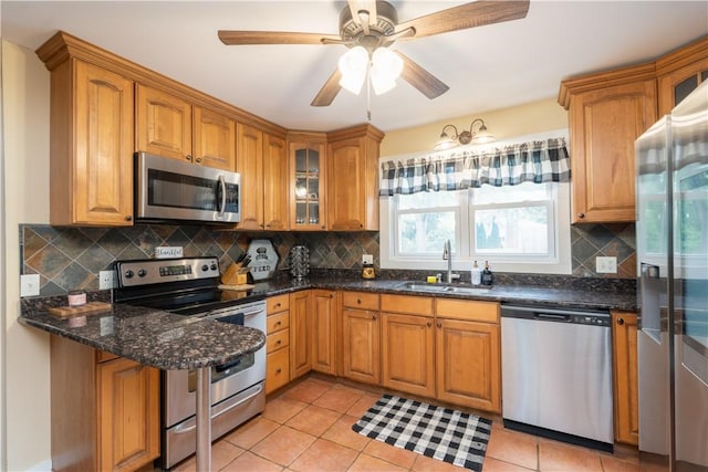 70 E Main St, Avon, NY 14414 - kitchen with stainless steel appliances, glass insert cabinets, backsplash, and brown cabinetry