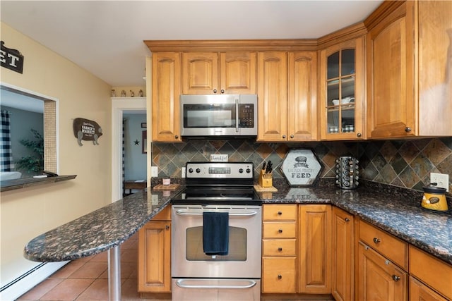 70 E Main St, Avon, NY 14414 - kitchen with appliances with stainless steel finishes, glass insert cabinets, tasteful backsplash, and dark stone countertops