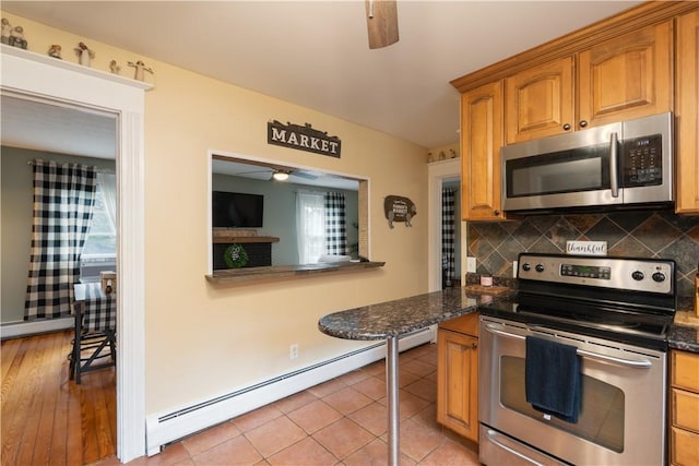70 E Main St, Avon, NY 14414 - kitchen featuring stainless steel appliances, a ceiling fan, a baseboard radiator, and healthy amount of natural light